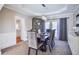 A dining room set with a table set for dinner, cabinets and french doors at 6450 Oak Valley Dr, Cumming, GA 30040