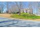 Charming two-story brick home featuring a well-manicured front yard and a welcoming entrance at 6450 Oak Valley Dr, Cumming, GA 30040