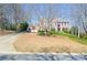 Charming two-story brick home featuring a well-manicured front yard and a welcoming entrance at 6450 Oak Valley Dr, Cumming, GA 30040