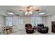 Finished basement featuring two recliner chairs, a table and chairs, and a door at 8030 Eagle Lake Vw, Cumming, GA 30028