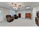 Finished basement area featuring two recliner chairs, a door, and a ceiling fan at 8030 Eagle Lake Vw, Cumming, GA 30028