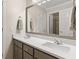 Bathroom featuring double sinks with light countertops and vanity, a large mirror, and tile flooring at 8030 Eagle Lake Vw, Cumming, GA 30028