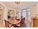 Elegant dining room featuring a chandelier, bay window and hardwood floors with an area rug at 8030 Eagle Lake Vw, Cumming, GA 30028
