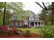 Brick home with a welcoming front porch, colorful landscaping and well-manicured lawn at 8030 Eagle Lake Vw, Cumming, GA 30028