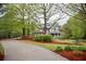 Charming two-story home featuring manicured lawn, mature trees, and a winding driveway at 8030 Eagle Lake Vw, Cumming, GA 30028