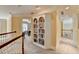 Bright hallway features a built-in bookcase and neutral decor at 8030 Eagle Lake Vw, Cumming, GA 30028