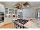 Close up of a kitchen with granite counters, stainless appliances, modern cabinets, and an exhaust hood at 8030 Eagle Lake Vw, Cumming, GA 30028