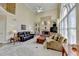 Bright and airy living room featuring a fireplace, built-in cabinets, large windows and high ceilings at 8030 Eagle Lake Vw, Cumming, GA 30028