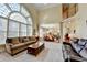 Open concept living room featuring large windows, fireplace, high ceilings and access to kitchen and upper level at 8030 Eagle Lake Vw, Cumming, GA 30028
