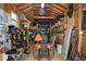The shed interior has a tractor, tools, equipment and shelving for organized storage at 8030 Eagle Lake Vw, Cumming, GA 30028
