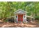 The barn is a delightful outdoor space with dual doors, covered porches, and custom lettering at 8030 Eagle Lake Vw, Cumming, GA 30028