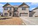 Inviting two-story home with a brick facade and a three-car garage at 975 Matt Springs Ct, Lawrenceville, GA 30045