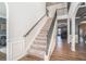 Elegant staircase with wrought iron railings and hardwood floors at 975 Matt Springs Ct, Lawrenceville, GA 30045