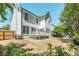 Spacious backyard with a wooden deck and fence, complemented by lush greenery at 12495 Concord Hall Dr, Alpharetta, GA 30005
