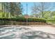 Community basketball court with hoop and lighting surrounded by lush landscaping at 12495 Concord Hall Dr, Alpharetta, GA 30005