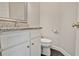 Half-bathroom featuring a granite countertop, white cabinets, and modern fixtures at 12495 Concord Hall Dr, Alpharetta, GA 30005