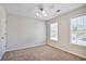 Neutral colored bedroom featuring carpeting and two windows providing natural light at 12495 Concord Hall Dr, Alpharetta, GA 30005