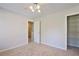 Bedroom featuring neutral carpet, a ceiling fan, and closet with shelving at 12495 Concord Hall Dr, Alpharetta, GA 30005