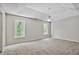 Large bedroom with patterned ceiling, ceiling fan, and two large windows at 12495 Concord Hall Dr, Alpharetta, GA 30005