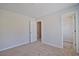 Bedroom with neutral carpet, a walk-in closet, and view into hall at 12495 Concord Hall Dr, Alpharetta, GA 30005