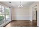 Bright dining room features hardwood floors, neutral walls and a chandelier style light fixture at 12495 Concord Hall Dr, Alpharetta, GA 30005
