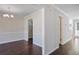 Dining area features dark wood floors, white trim and paint, along with a modern light fixture at 12495 Concord Hall Dr, Alpharetta, GA 30005