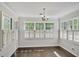 Dining area is bright with lots of windows, white shutters, and hardwood floors at 12495 Concord Hall Dr, Alpharetta, GA 30005