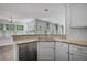 This gorgeous kitchen features white cabinets and stainless steel appliances along with granite countertops at 12495 Concord Hall Dr, Alpharetta, GA 30005