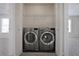 Laundry closet with newer washer and dryer units, with bedrooms visible on both sides at 12495 Concord Hall Dr, Alpharetta, GA 30005