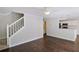 Open-concept living room showcasing hardwood floors and a staircase leading to the upper level at 12495 Concord Hall Dr, Alpharetta, GA 30005