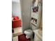 Bathroom with vanity and toilet with storage, plus a view into the adjacent living room at 1727 Walt Stephens Rd, Jonesboro, GA 30236