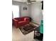 Cozy living room with red sofa, ceiling fan, and window with natural light at 1727 Walt Stephens Rd, Jonesboro, GA 30236