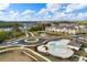 Aerial view showcasing the community with a pool, pond, and well-maintained landscaping at 3848 Hester St, Duluth, GA 30097