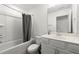 Clean bathroom featuring a tub with shower, a sink with vanity, and a toilet at 3848 Hester St, Duluth, GA 30097