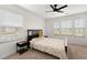 Bright bedroom featuring a ceiling fan, multiple windows, and carpet floors at 3848 Hester St, Duluth, GA 30097