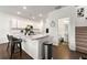Stylish kitchen with a center island, stainless steel appliances and adjacent bathroom and stairs at 3848 Hester St, Duluth, GA 30097