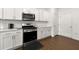 Modern kitchen featuring stainless steel appliances, white cabinets, and quartz countertops at 3848 Hester St, Duluth, GA 30097