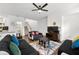 Cozy living room with a ceiling fan, plush couches, area rug and a flat screen TV at 3848 Hester St, Duluth, GA 30097