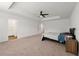 Open main bedroom featuring carpet, a ceiling fan, and an en-suite bathroom at 3848 Hester St, Duluth, GA 30097