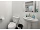 Bright powder room featuring a pedestal sink, modern fixtures, and a neutral color palette at 3848 Hester St, Duluth, GA 30097