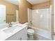 Bathroom with a white vanity, toilet, and tub-shower combo for relaxation and convenience at 5885 Waggoner Cv, Rex, GA 30273