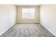 A cozy bedroom featuring neutral walls and plush carpeting under a bright window at 5885 Waggoner Cv, Rex, GA 30273