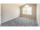 A bright bedroom with plush carpeting and natural light from a large window at 5885 Waggoner Cv, Rex, GA 30273