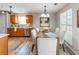 Kitchen and dining area featuring stainless steel appliances, wood cabinets, and a dining table with seating at 5885 Waggoner Cv, Rex, GA 30273