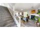 Open-concept living room with staircase and fireplace and seating, creating a cozy and inviting atmosphere at 5885 Waggoner Cv, Rex, GA 30273