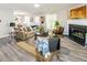 Cozy living room with a fireplace, plush seating, and an open view of the dining area at 5885 Waggoner Cv, Rex, GA 30273