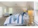 Bright main bedroom showcasing natural light, carpet floors, and accent furniture with a luxurious mattress and headboard at 5885 Waggoner Cv, Rex, GA 30273