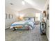 Bright main bedroom showcasing vaulted ceiling, carpet floors, accent furniture, and natural light from the windows at 5885 Waggoner Cv, Rex, GA 30273