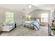 Bright main bedroom showcasing vaulted ceiling, carpet floors, accent furniture, and a relaxing sitting chair at 5885 Waggoner Cv, Rex, GA 30273