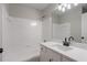 Well-lit bathroom with a combined tub and shower, and vanity with solid surface at 2545 Davenport Park Dr, Duluth, GA 30096